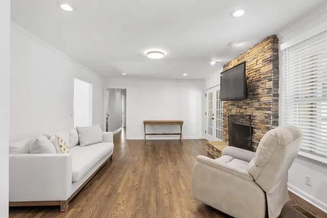 a living room with furniture a fireplace and a flat screen tv