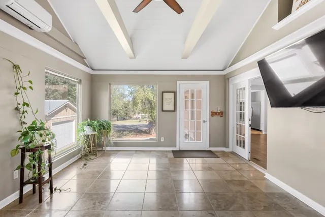 a view of a hallway with furniture and front door