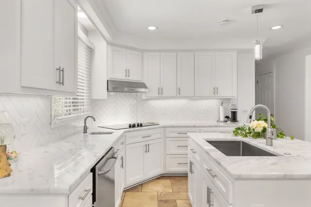 a kitchen with a sink a stove a refrigerator cabinets and a counter top space