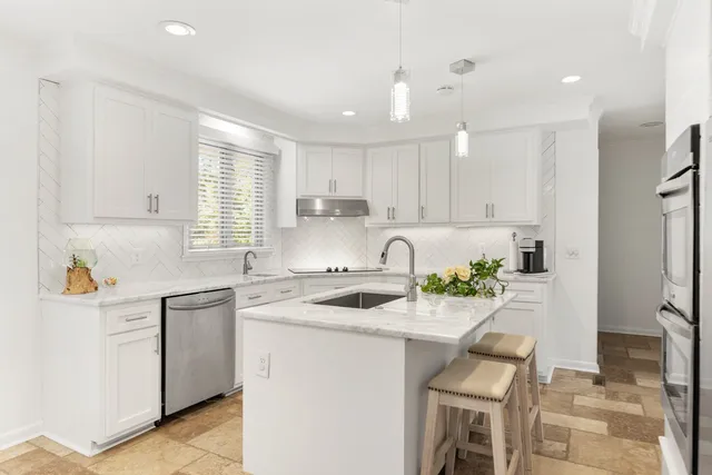 a kitchen with a refrigerator sink and cabinets