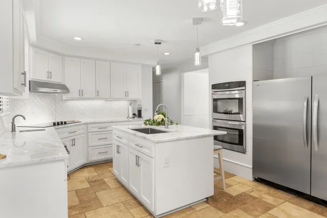 a kitchen with a refrigerator and a sink