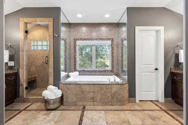 a spacious bathroom with a granite countertop sink and a mirror