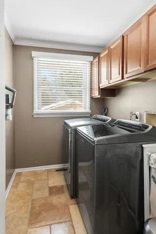 a view of an empty room with wooden floor and a ceiling fan