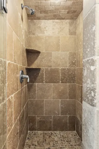 a bathroom with a granite countertop tub sink and mirror