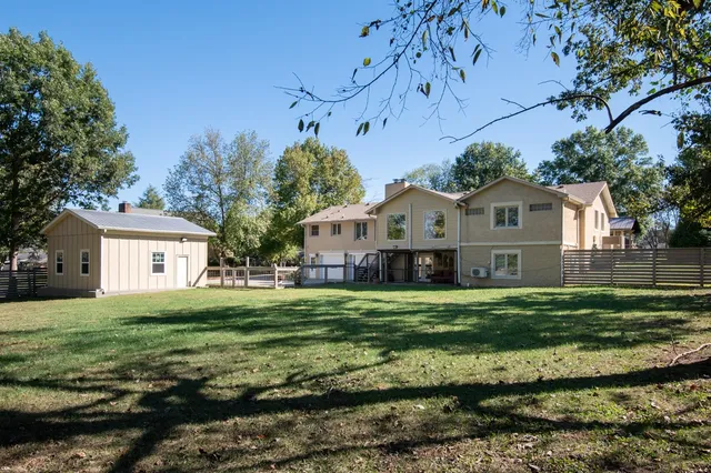 a view of a grassy field with trees