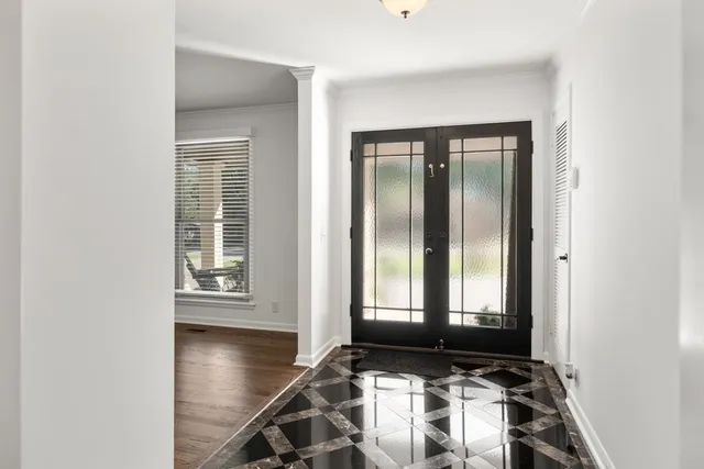 a view of a room with wooden floor and windows
