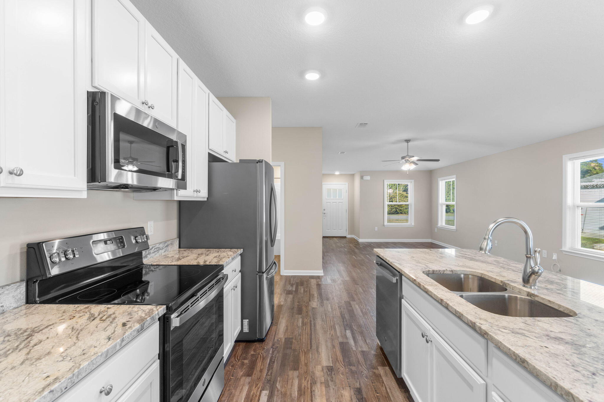 145 4th Avenue Crestview, FL 32539 - Photo 11 of 31 a kitchen with stainless steel appliances granite countertop a sink stove and refrigerator