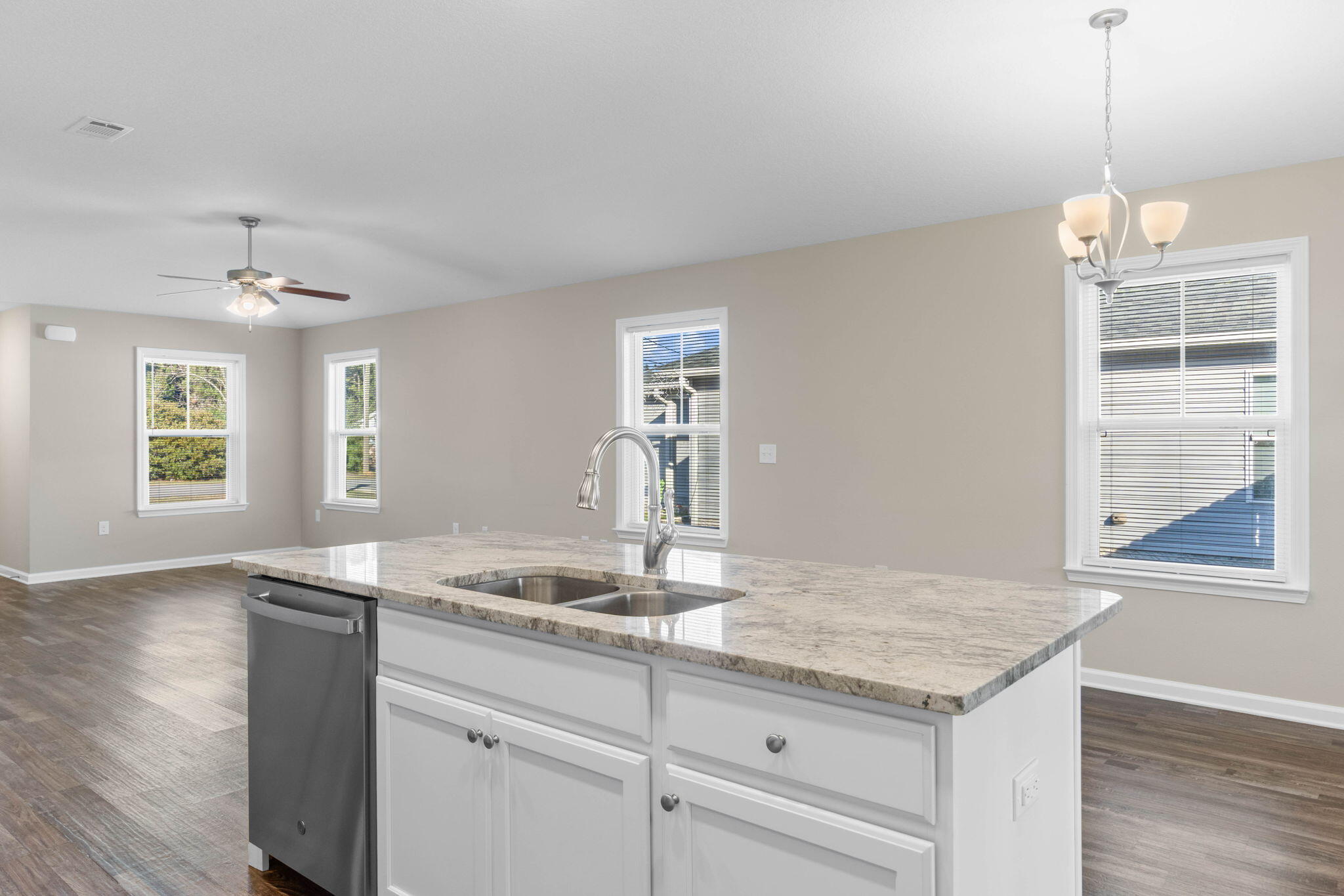145 4th Avenue Crestview, FL 32539 - Photo 13 of 31 a kitchen with granite countertop a sink cabinets and wooden floor