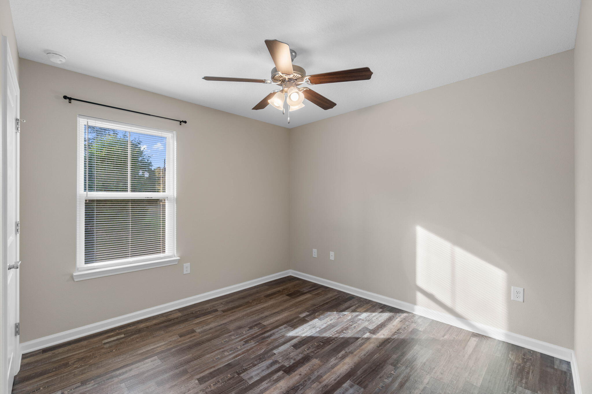 145 4th Avenue Crestview, FL 32539 - Photo 18 of 31 wooden floor in an empty room with a window