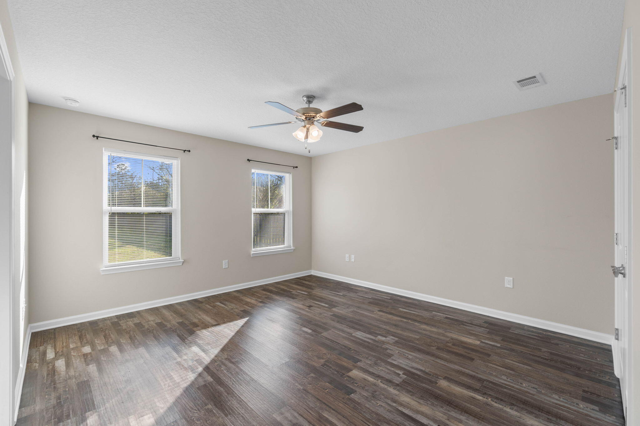 145 4th Avenue Crestview, FL 32539 - Photo 20 of 31 an empty room with wooden floor and windows