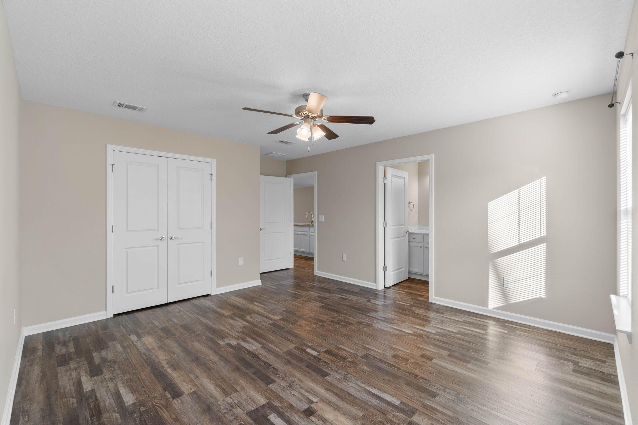 145 4th Avenue Crestview, FL 32539 - Photo 22 of 31 a view of an empty room with wooden floor and a window