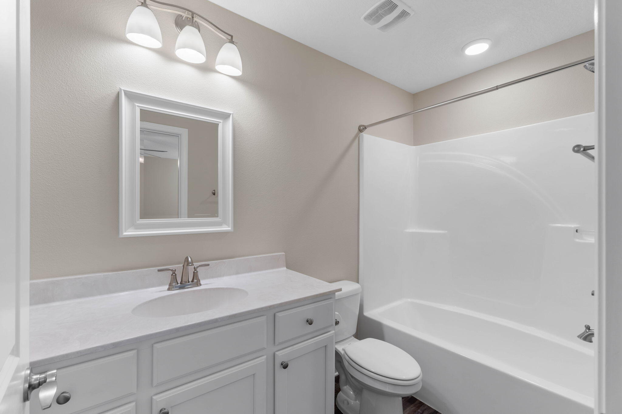 145 4th Avenue Crestview, FL 32539 - Photo 24 of 31 a bathroom with a toilet a sink a mirror a bathtub and vanity
