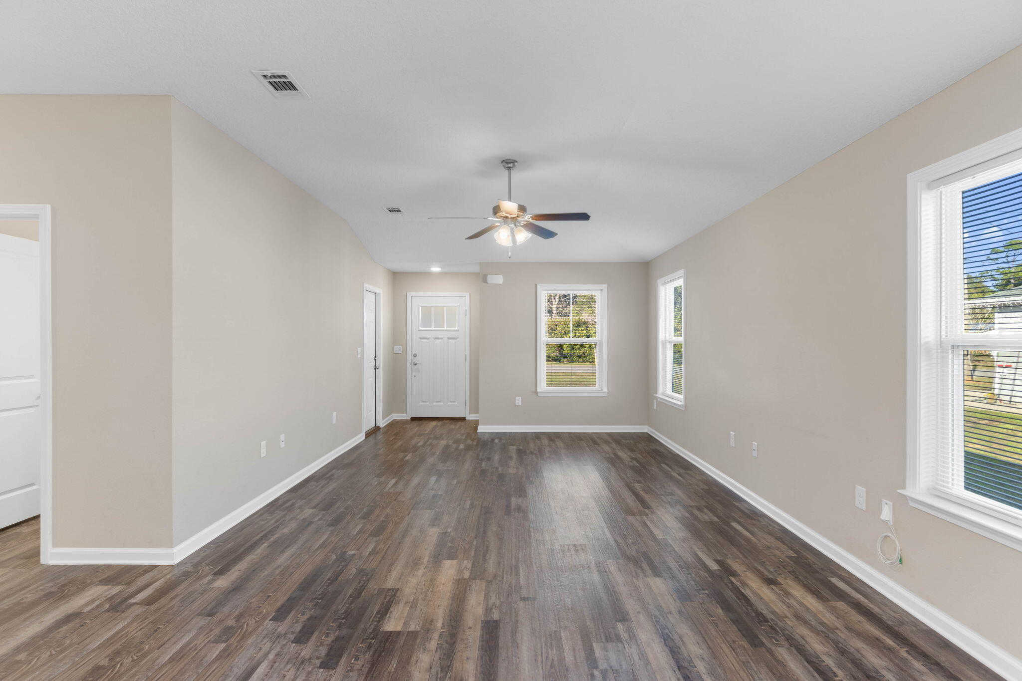 145 4th Avenue Crestview, FL 32539 - Photo 4 of 31 wooden floor in an empty room with a window