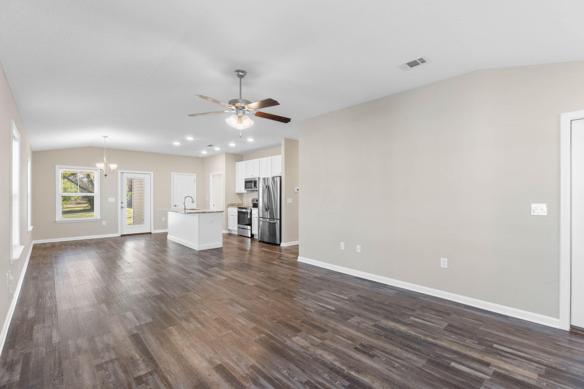 145 4th Avenue Crestview, FL 32539 - Photo 6 of 31 wooden floor in an empty room with a window