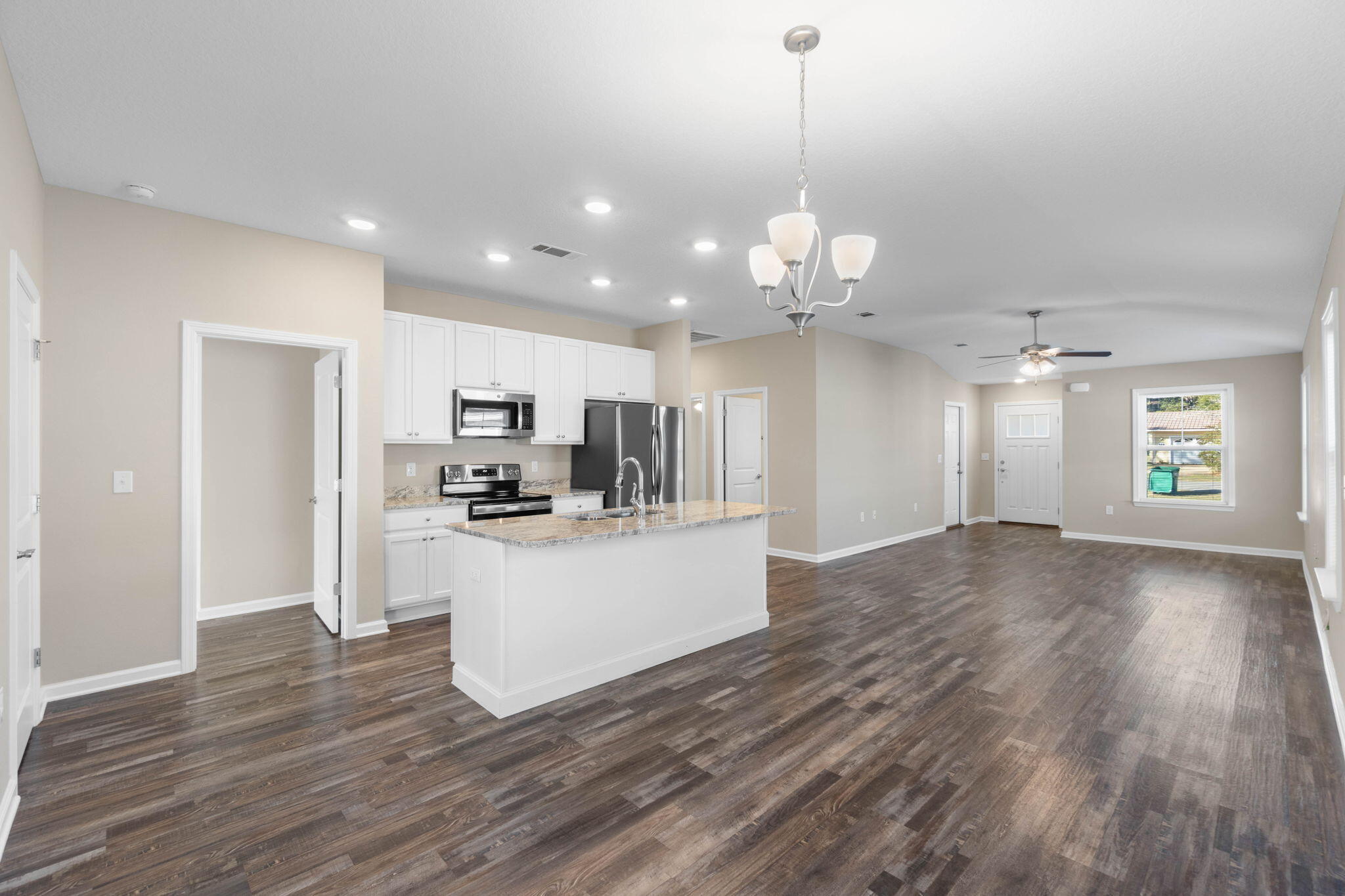 145 4th Avenue Crestview, FL 32539 - Photo 8 of 31 a view of a kitchen with stove and wooden floor