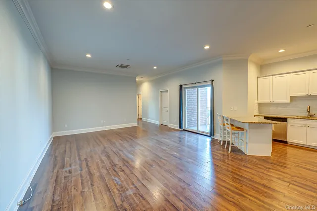 a view of kitchen with cabinets and wooden floor