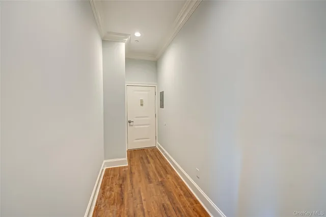 a view of hallway with wooden floor