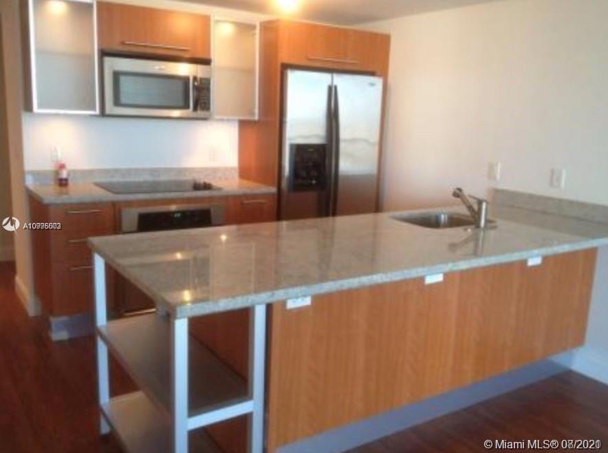 185 Southwest 7th Street, Unit 3403 Miami, FL 33130 - Photo 2 of 34 a kitchen with a sink and a microwave