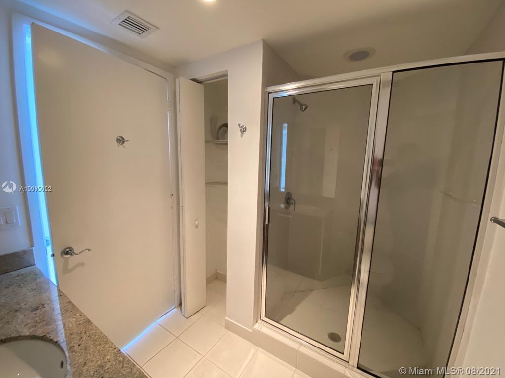 185 Southwest 7th Street, Unit 3403 Miami, FL 33130 - Photo 17 of 34 a bathroom with a glass door shower