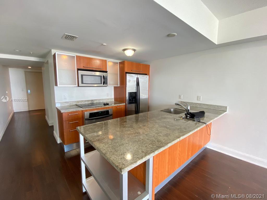 185 Southwest 7th Street, Unit 3403 Miami, FL 33130 - Photo 3 of 34 a kitchen with stainless steel appliances granite countertop a stove and a sink