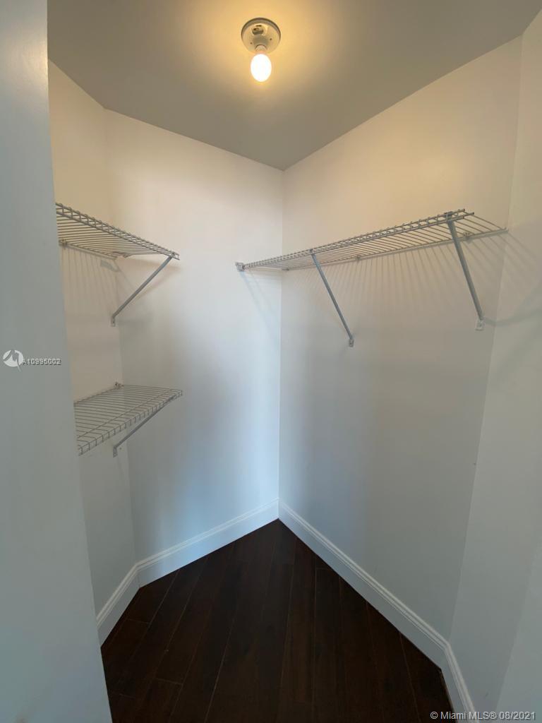 185 Southwest 7th Street, Unit 3403 Miami, FL 33130 - Photo 30 of 34 a view of small space with racks on the wall