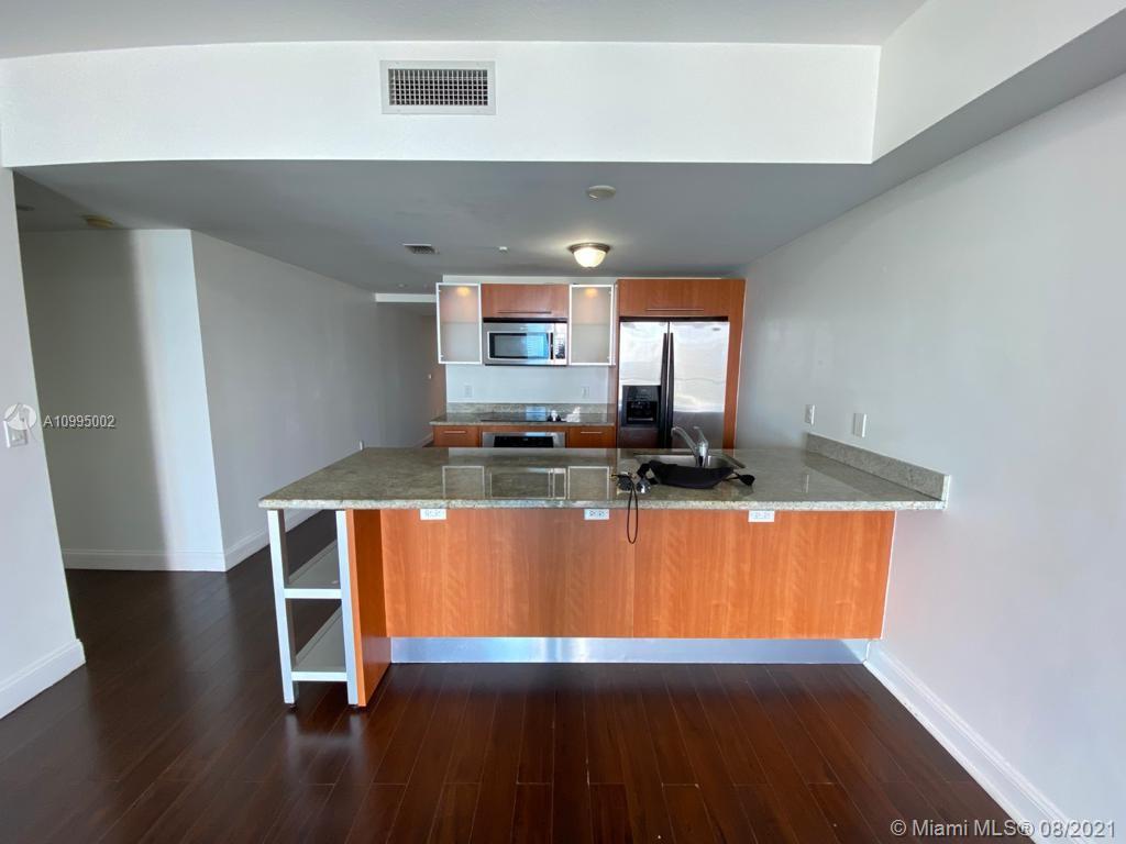 185 Southwest 7th Street, Unit 3403 Miami, FL 33130 - Photo 4 of 34 a living room with wooden floor and pool table