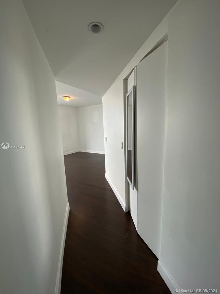 185 Southwest 7th Street, Unit 3403 Miami, FL 33130 - Photo 31 of 34 a view of a hallway with wooden floor