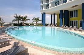 185 Southwest 7th Street, Unit 3403 Miami, FL 33130 - Photo 32 of 34 a swimming pool with outdoor seating and yard