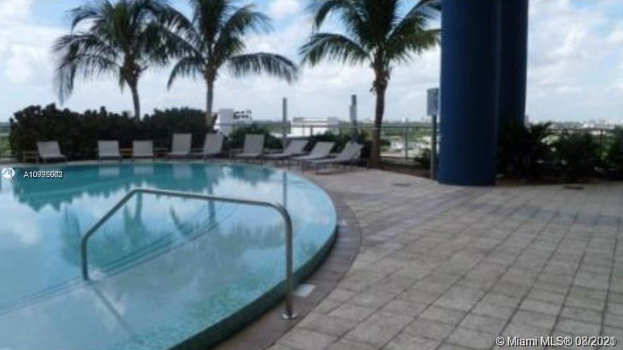 185 Southwest 7th Street, Unit 3403 Miami, FL 33130 - Photo 33 of 34 a view of swimming pool with a table and chair