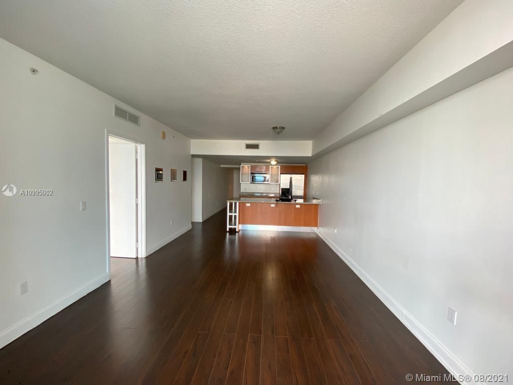 185 Southwest 7th Street, Unit 3403 Miami, FL 33130 - Photo 7 of 34 a view of a room with wooden floor