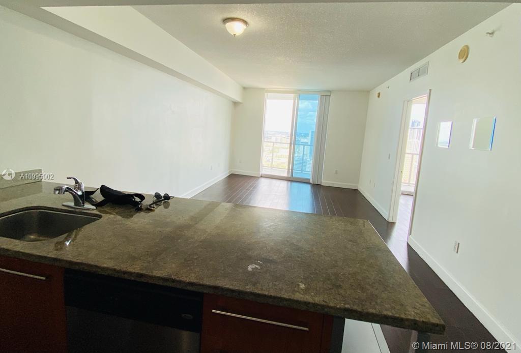 185 Southwest 7th Street, Unit 3403 Miami, FL 33130 - Photo 8 of 34 a view of a kitchen cabinets a sink and dishwasher