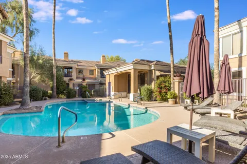 a view of a house with swimming pool and sitting area