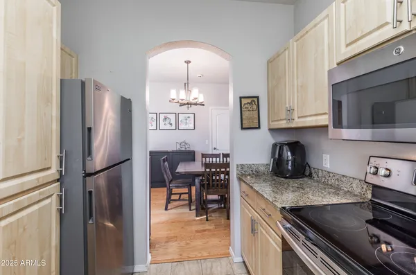 a kitchen with granite countertop a stove and a microwave