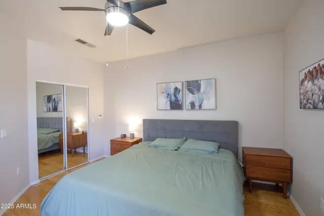 a bedroom with a bed and a chandelier