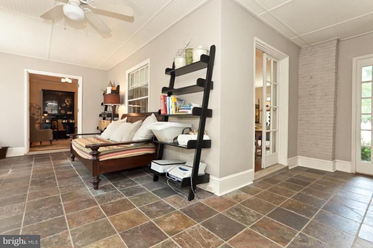 108 Longwood Road Baltimore, MD 21210 - Photo 11 of 28 a living room with patio furniture and a fireplace