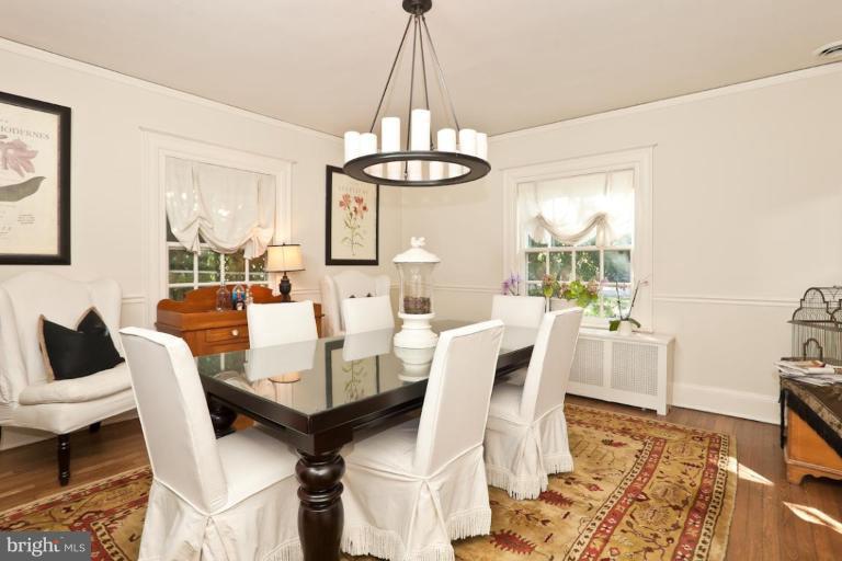 108 Longwood Road Baltimore, MD 21210 - Photo 18 of 28 a living room with furniture a chandelier and a table