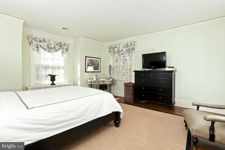 108 Longwood Road Baltimore, MD 21210 - Photo 3 of 28 a bedroom with a bed and a flat screen tv