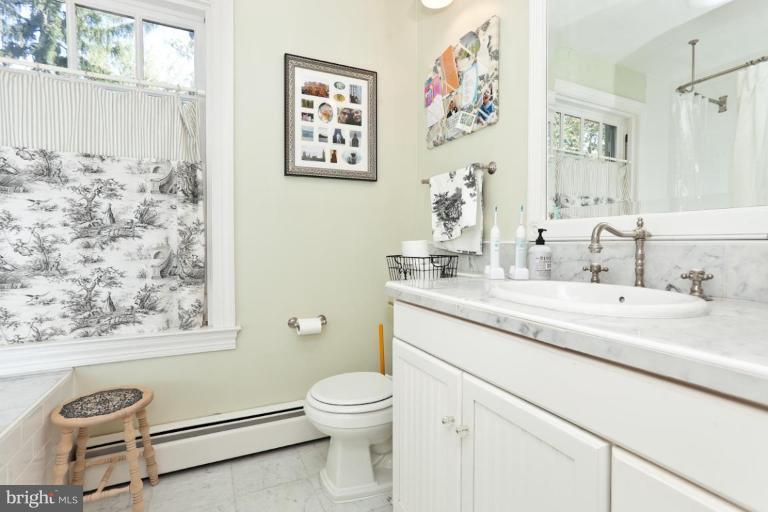 108 Longwood Road Baltimore, MD 21210 - Photo 5 of 28 a bathroom with a granite countertop toilet sink and mirror