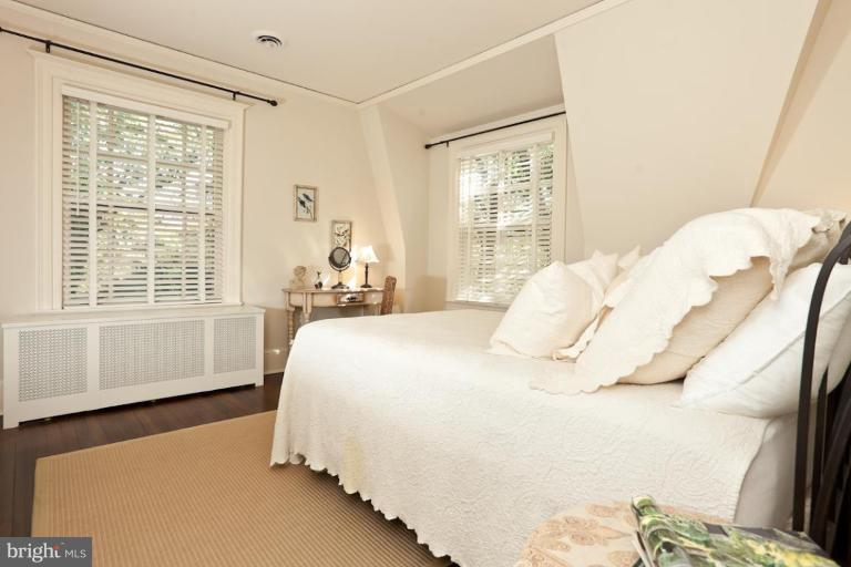 108 Longwood Road Baltimore, MD 21210 - Photo 6 of 28 a bedroom with a bed and wooden floor