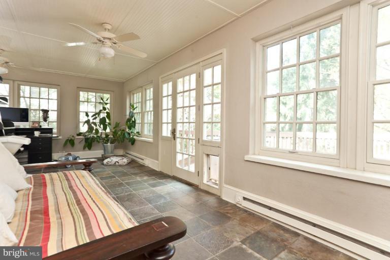 108 Longwood Road Baltimore, MD 21210 - Photo 10 of 28 a living room filled with furniture hardwood floor and a large window