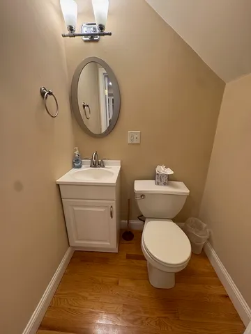a bathroom with a sink toilet and a mirror