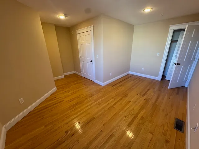 a view of hallway with wooden floor