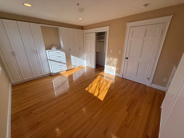 a view of a room with wooden floor