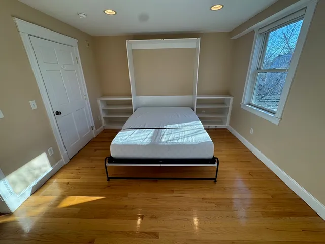 a room with wooden floor and window