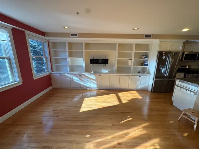 a view of a living room with furniture and a flat screen tv