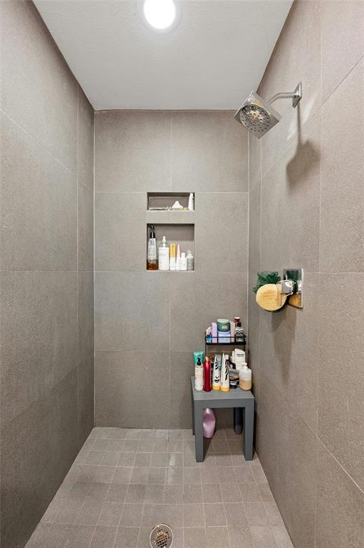 2802 Warren Street, Unit A Austin, TX 78703 - Photo 18 of 29 a white bath tub sitting next to a white sink and a shower