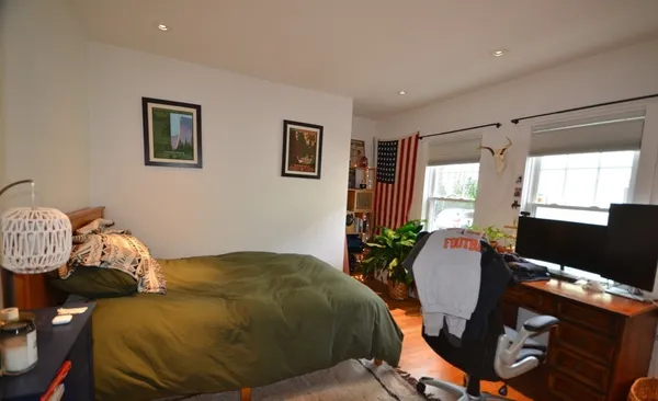 a bed room with a bed mirror and a window