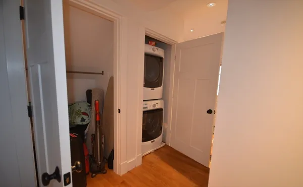a view of a hallway with closet and bathroom
