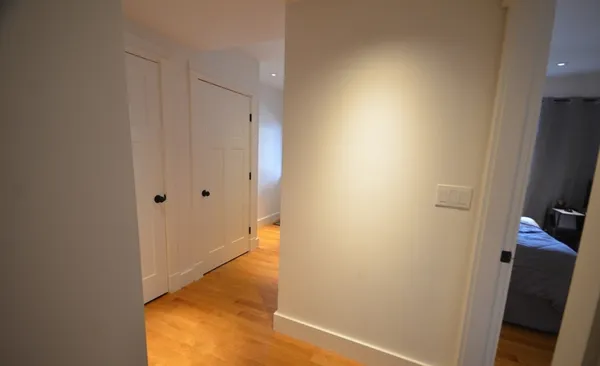 a view of hallway with wooden floor