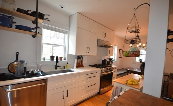 a kitchen with a sink appliances and cabinets